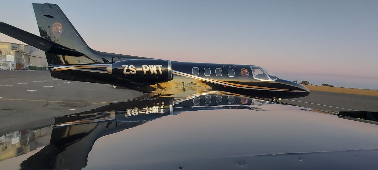 Citation 500 ZS-PWT reflected in a wing at sunset